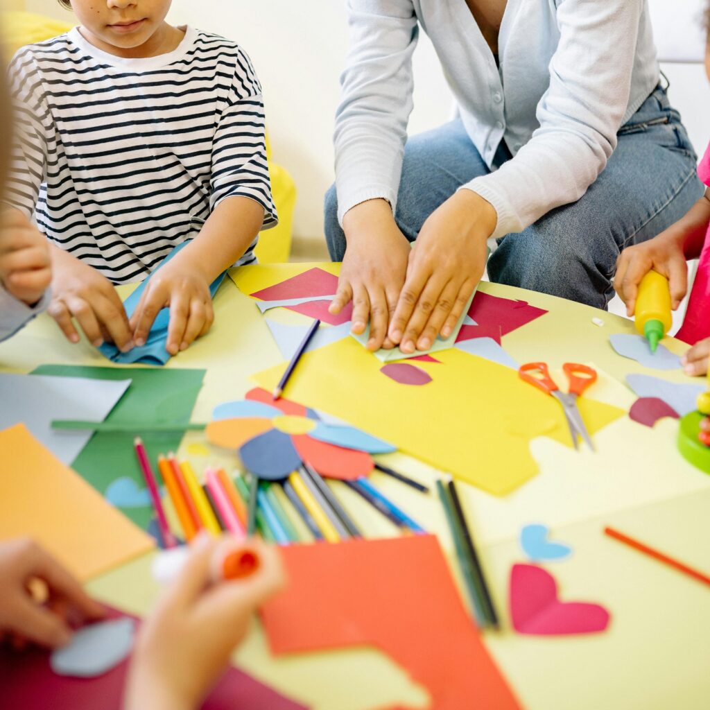 Woman Teaching The Children Arts and Crafts